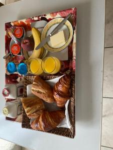 a refrigerator filled with croissants and other foods at STUDIO BEAUREGARD - TERRASSE et JARDIN in Nancy