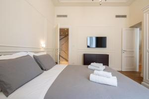 a bedroom with a large bed with towels on it at Florence Luxury Apartment al Duomo in Florence