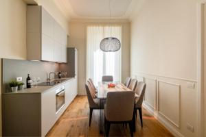 a kitchen with a dining room table and chairs at Florence Luxury Apartment al Duomo by Mmega in Florence