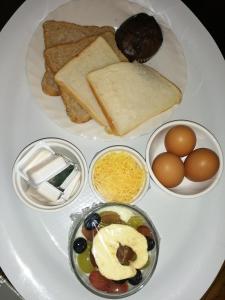a plate of food with eggs bread and other ingredients at Swartberg Guest House in Caledon