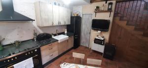 a small kitchen with a sink and a stove at La Cantina in Chanos +19 photos