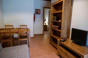 een woonkamer met een televisie en een eettafel bij Eras del Poeta in Casillas