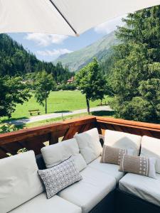 a white couch on a balcony with a view of a mountain at Villa Rosa in Bad Gastein