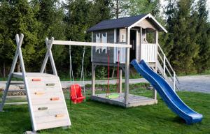 a playground with a slide and a play house at BiesCzadowa Dolina in Ustrzyki Dolne