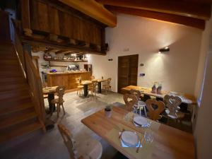 a dining room with wooden tables and chairs at Giasson in Valgrisenche