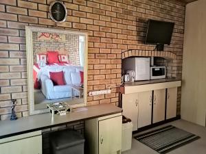 a brick wall with a picture of a bedroom at Lewens-Essens on C in Yzerfontein