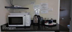 a microwave sitting on top of a kitchen counter at Country Lane Guesthouse in Howick