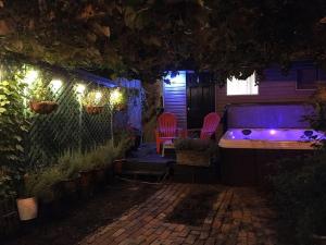 a backyard at night with a hot tub and chairs at Love-nest With Private Hot Tub in Toronto