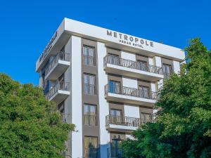 
a large building with a clock on the front of it at Metropole Urban Hotel in Heraklio Town
