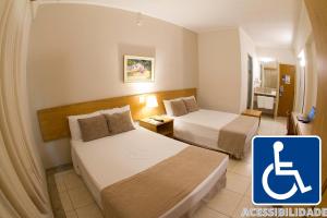 En eller flere senger på et rom på Hotel Dan Inn Franca & Convenções
