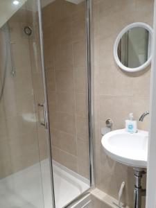 a bathroom with a shower and a sink at Horseshoe Forge Plover Cottage Lindley in Huddersfield