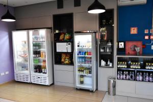 two refrigerators are in a store with drinks at Água Branca Park Hotel in Araçatuba