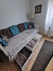 a couch in a living room with open drawers at STUDIO 2 étoiles Rénové Proche des THERMES in Lamalou-les-Bains