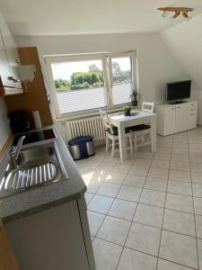 een keuken met een wastafel en een tafel met een tafel bij Wohnung auf dem Lande in Riepsdorf +23 foto's