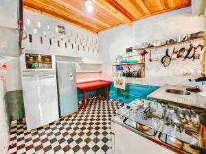 a kitchen with a sink and a red table at Camping Marymar in Paraty