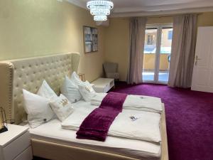 sypialnia z dużym łóżkiem i fioletowym dywanem w obiekcie Hotel Restaurant Hesch w mieście Gabersdorf