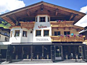 a building with a sign on the front of it at La Tombola Appartements in Gerlos