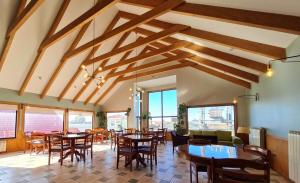 a dining room with wooden tables and chairs at Hotel Carpa Manzano in Punta Arenas