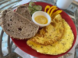 a plate of breakfast food with eggs and toast at Alf Leila Boutique Hotel in Dahab