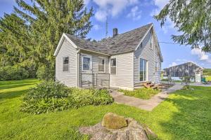 a small white house with a grass yard at Eclectic Ladysmith Hideaway Hike and Hunt! in Ladysmith