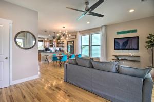 a living room with a couch and a ceiling fan at Bright Tybee Island Townhome - Walk to the Beach! in Tybee Island