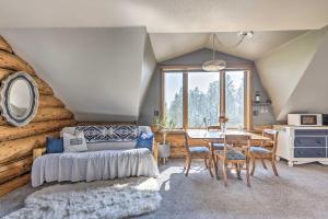 a room with a bed and a table with chairs at Fraser Couples Hideaway with Indian Peaks View in Fraser