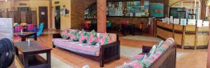 a living room filled with lots of furniture at Cool Vibes Beach Hostel in Dominical