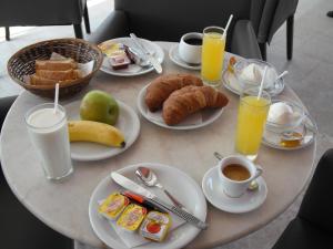 a table topped with plates of breakfast foods and drinks at Antonis Hotel in Kefalos