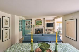 a living room with a blue couch and a table at Bridlepath Cottage in West Woodhay