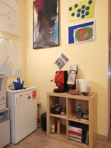 a room with a small shelf next to a refrigerator at ZAHRA ARAGONA in Aragona