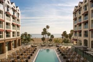 a view of the pool at a resort with chairs and a hotel at Loews Santa Monica Beach Hotel in Los Angeles