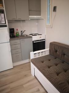 a small kitchen with a sink and a stove at Ukonloma Cottages in Rovaniemi