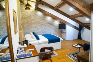 a bedroom with a bed and a desk in a room at Oblivion Luxury Rooms in Split