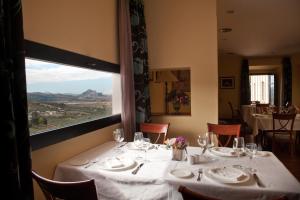 a dining room with a table with a view at Hotel Escuela Convento Sto Domingo in Archidona +8 photos