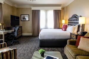 a hotel room with a large bed and a desk at The Lenox in Boston