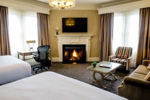 a hotel room with a bed and a fireplace at The Lenox in Boston