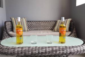 two bottles of oil and two glasses on a table at Luxury Couples Paradise*ensuite Jacuzzi and Pool in Trianon