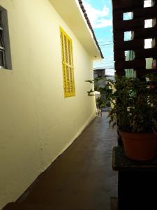 a white building with a window and some plants at Infinito Suíte in Sao Paulo