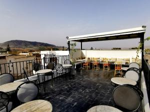 a restaurant with tables and chairs on a patio at Cine House in Fez