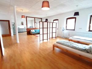 a large room with a bed and a wooden floor at Geräumige Wohnung in zentraler Lage in Emskirchen