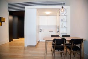 a kitchen and dining room with a wooden table and chairs at FLH Praça Comércio Wood Design Flat in Lisbon