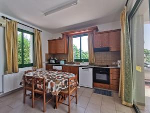 a kitchen with a table with a table cloth on it at VILLA VAGGELIS in Paphos