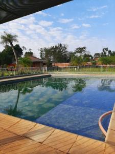 a swimming pool with a chair next to it at Mi Buen Refugio in Puerto Iguazú