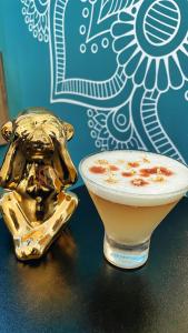 a gold animal shaped drink next to a plate of food at The Secret Garden Hostel in Lima