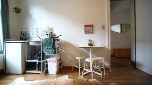 uma cozinha com uma mesa e bancos num quarto em Rétro Studio em Bruxelas