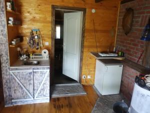 a kitchen with a sink and a refrigerator at Galerija68 in Kraljevo