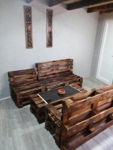 a room with wooden chairs and a table in it at Galerija68 in Kraljevo