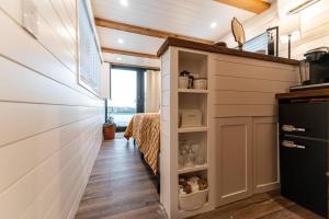 a hallway of a tiny house with a bed at Deer Creek Tiny Container Home-12 Min to Magnolia in Bellmead