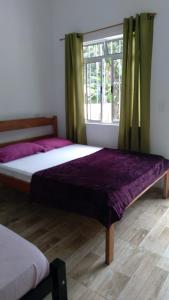 Un pat sau paturi într-o cameră la Pousada Sossego da Vila - Trindade Paraty