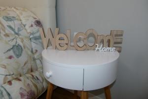 a toilet with a welcome sign on top of it at My Home Saronno in Saronno +5 photos